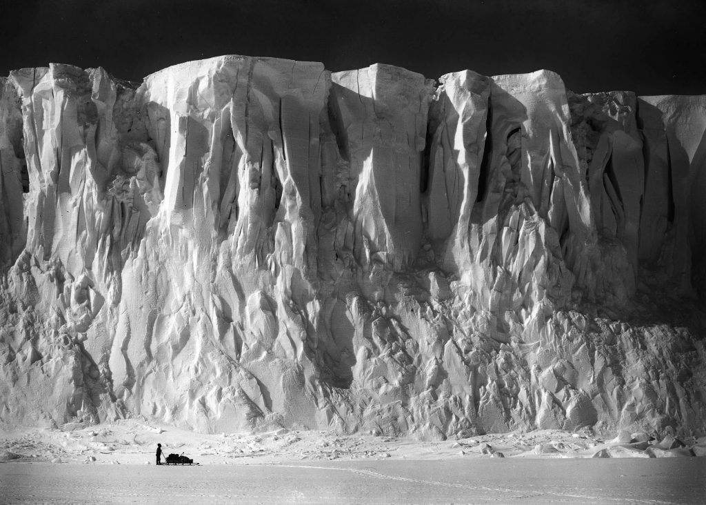 H.G Ponting. Captain Scott+s Antarctic Expedition 1910 - 1912. 2nd December, 1911. The ice cliffs at the end of the Barne Glacier with Mount Erebus in the background.