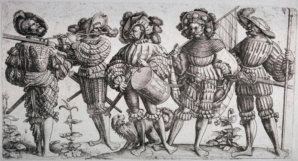 Die fünf Landsknechte - Daniel Hopfer, 1530 (Publiek Domein - wiki)- De extravagante kleding van de landsknechten heeft grote invloed gehad op het Nederlandse modebeeld. In de eerste helft van de zestiende eeuw kwamen de spleten in de stof, het brede silhouet, en het wijd uitlopende schoeisel van de Duitsers in gematigde vorm terug in de Nederlandse mode. 