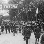 Belgische troepen met Belgische vlag, tijdens hun intrede in Tabora, 19 september 1916