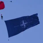 Parachutist met een NAVO-vlag