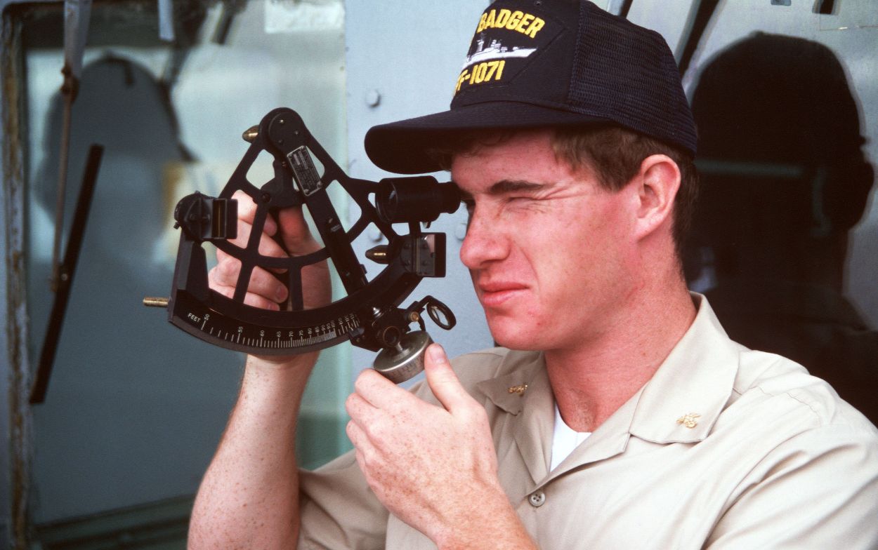 Een marineofficier in opleiding leest een sextant aan boord van het fregat USS Badger, 1986
