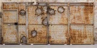 A metal door with bullet holes (2015) - Ai Weiwei