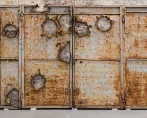 A metal door with bullet holes (2015) - Ai Weiwei