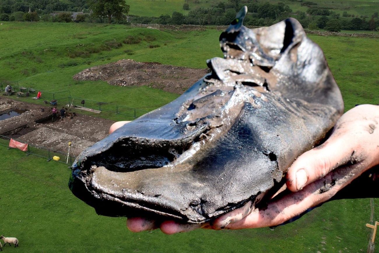 Een van de gevonden schoenen, met op de achtergrond de opgravingslocatie